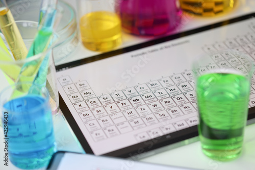 Billede på lærred Digital tablet with periodic system of elements lying on table in laboratory clo