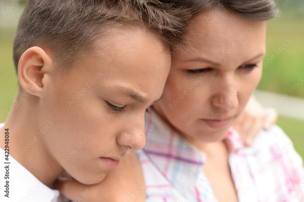 close up portrait of sad mother with son close up portrait of sad mother with son