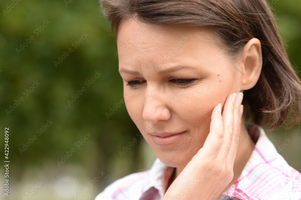 Beautiful young sad woman in park Beautiful young sad woman in park