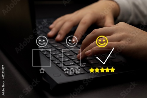 Customer service and Satisfaction concept ,Business people are touching the virtual screen on the happy Smiley face icon to give satisfaction in service. rating very