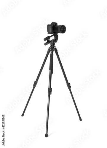 Modern tripod with camera isolated on white