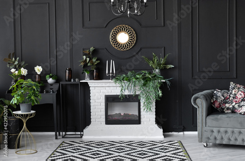luxury interior decor black wall with white brick fireplace, gold frame and gray sofa. classic black dining room style