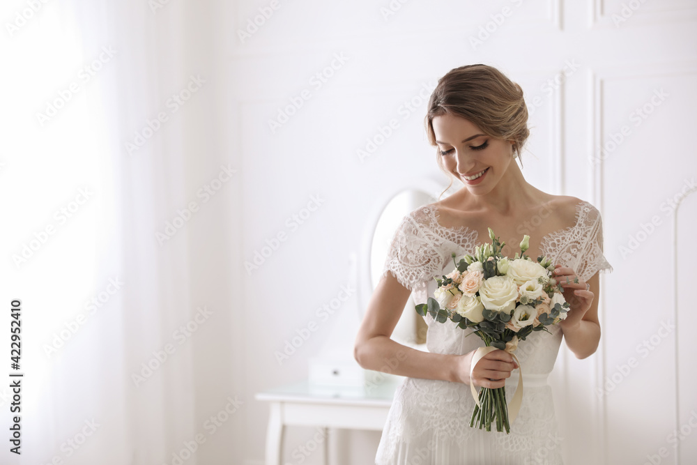 Bride in beautiful wedding dress with bouquet indoors. Space for text Bride in beautiful wedding dress with bouquet indoors. Space for text