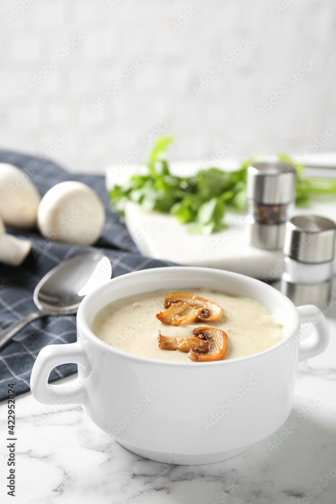 Delicious cream soup with mushrooms on white marble table Delicious cream soup with mushrooms on white marble table