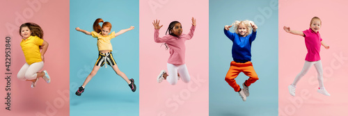 Young and happy kids gesturing isolated on multicolored studio background. Human emotions, facial expression concept © master1305