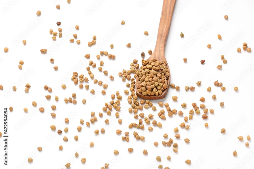 Dry raw organic chickpeas in a wooden spoon isolated on white background. Dry raw organic chickpeas in a wooden spoon isolated on white background.