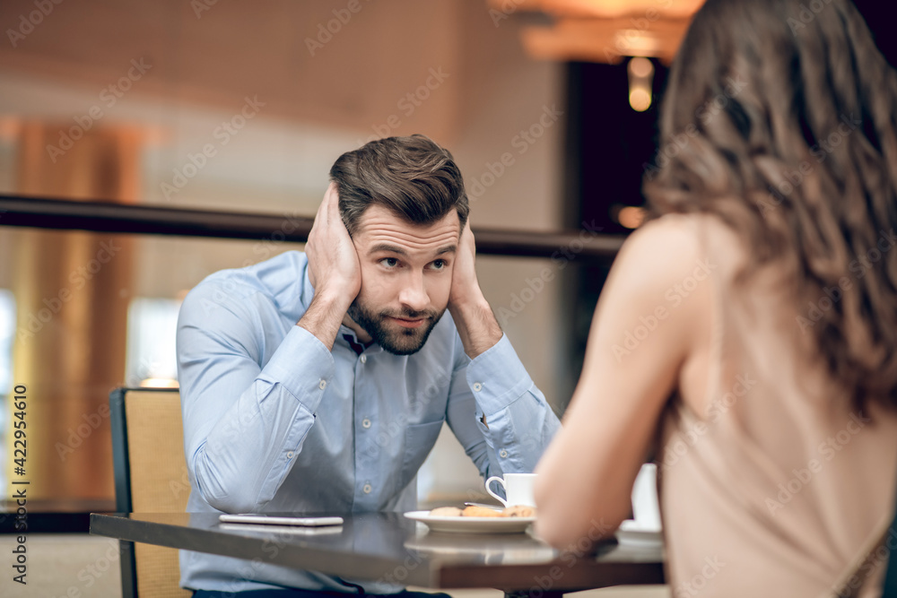 Man and woman having a blind date and looking disappointed Man and woman having a blind date and looking disappointed