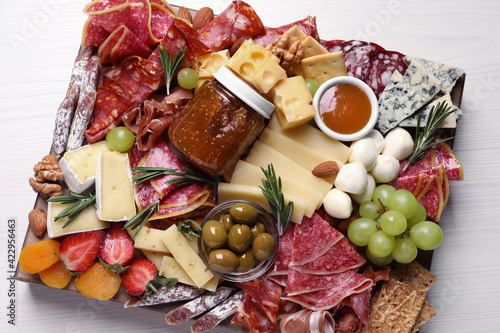 Assorted appetizers served on white wooden table, top view