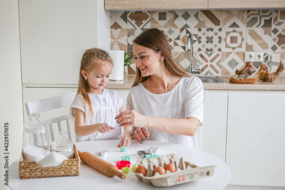 family, food and people concept - happy mother and daughter having breakfast at home family, food and people concept - happy mother and daughter having breakfast at home