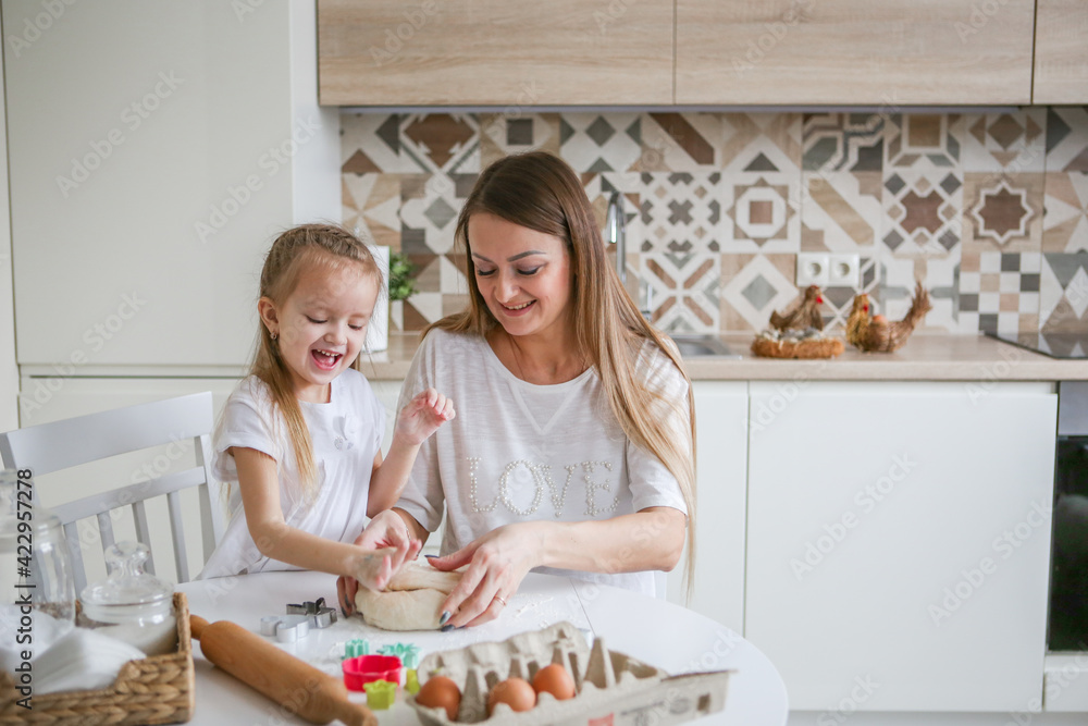 family, food and people concept - happy mother and daughter having breakfast at home family, food and people concept - happy mother and daughter having breakfast at home