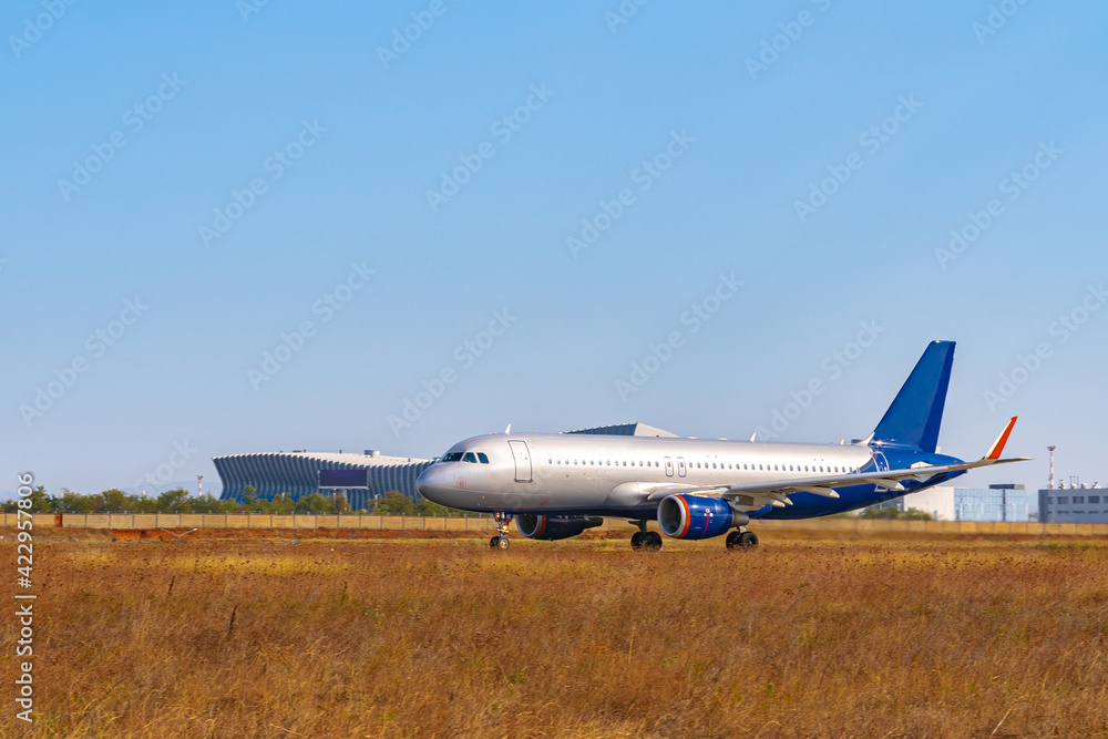 Big passenger airplane drives along the runway in airport Big passenger airplane drives along the runway in airport