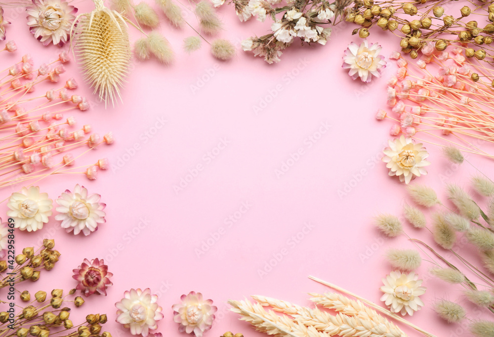 Frame of beautiful dried flowers on light pink background, flat lay. Space for text