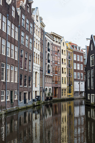 Amsterdam canal houses and their reflections in the water © Alena Petrachkova