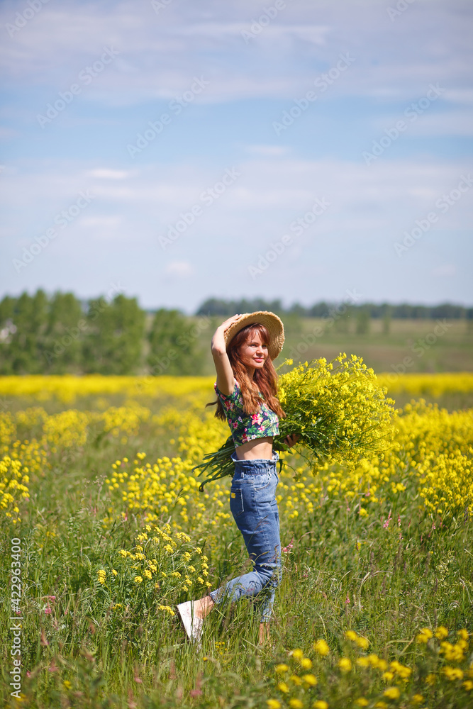 Young, beautiful woman in rapeseed field in the summer. Rural scene with attractive girl in hat enjoying sun in yellow blooming field. Concept of joy, happiness and freedom. Young, beautiful woman in rapeseed field in the summer. Rural scene with attractive girl in hat enjoying sun in yellow blooming field. Concept of joy, happiness and freedom.