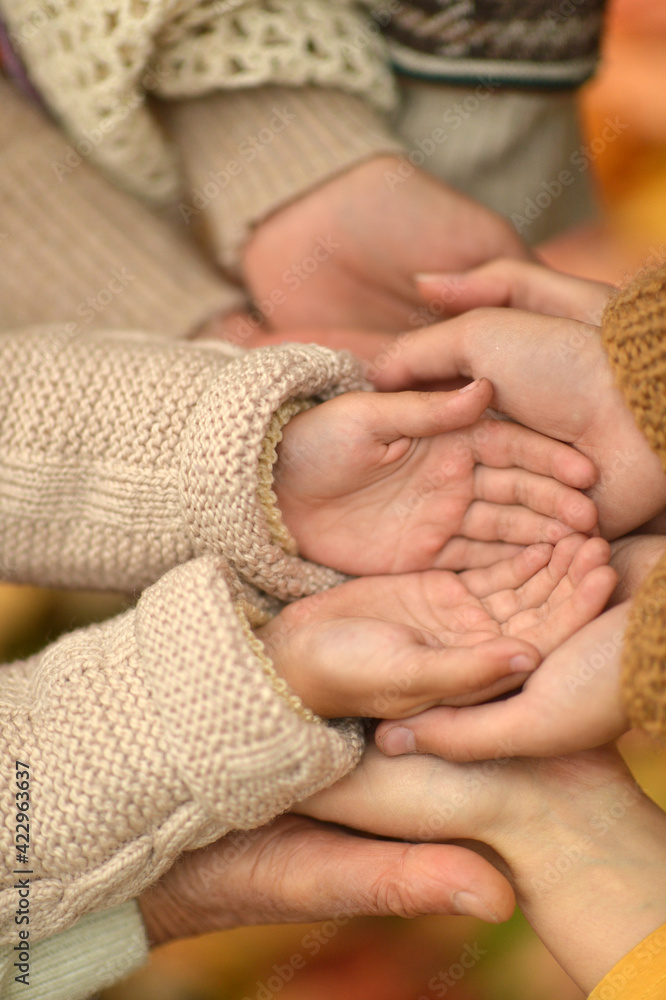cropped image, family putting hands together cropped image, family putting hands together
