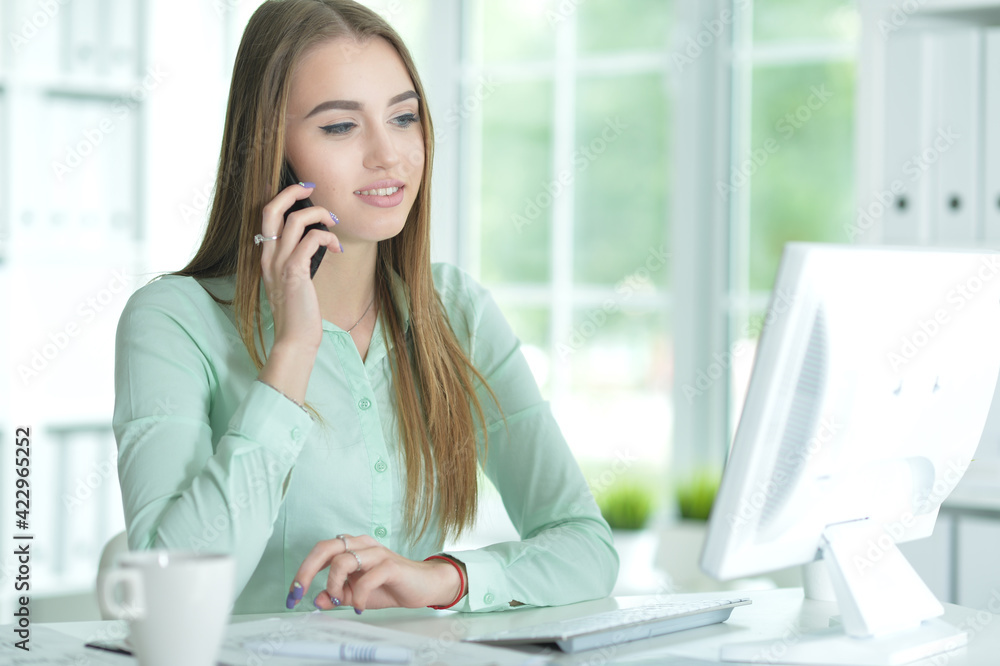 Portrait of businesswoman talking on smartphone in office Portrait of businesswoman talking on smartphone in office