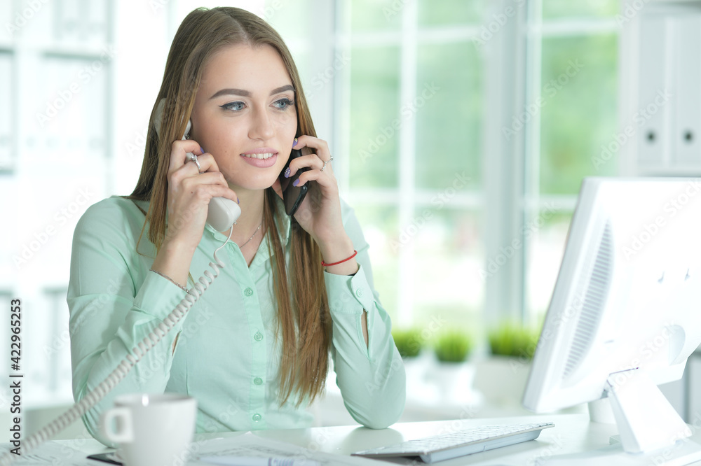 Portrait of businesswoman talking on phone in office Portrait of businesswoman talking on phone in office