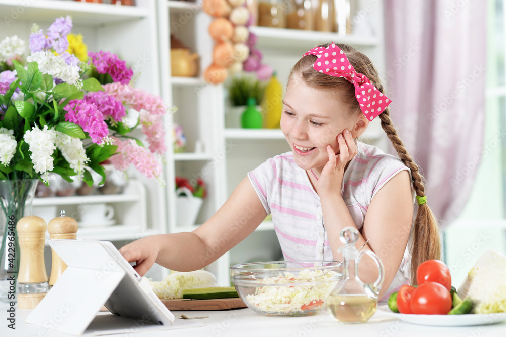 Cute girl preparing delicious fresh salad in kitchen Cute girl preparing delicious fresh salad in kitchen
