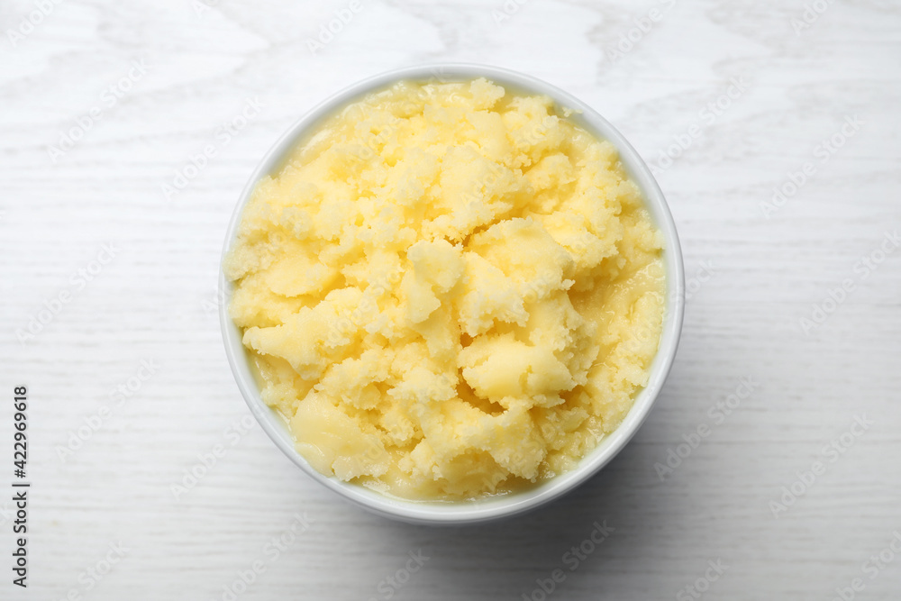Bowl of Ghee butter on white wooden table, top view Bowl of Ghee butter on white wooden table, top view