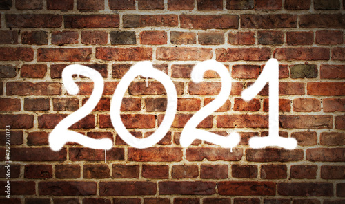 2021 year sign spray painted on the brick wall