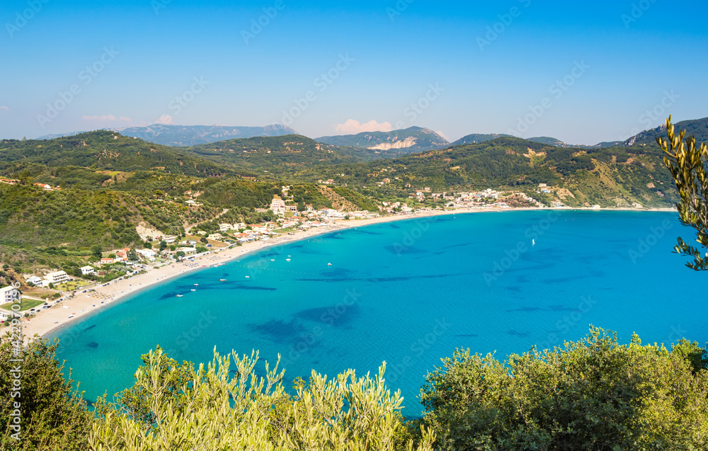 Porto Timoni beach on Corfu island in Greece. Beautiful panoramic view of green mountains, clear sea water, secluded Pirates bay and double stony beach. Famous destination for summer vacation