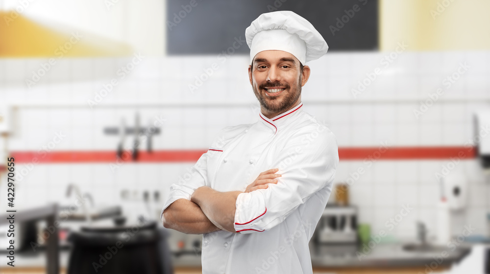 happy smiling male chef at restaurant kitchen