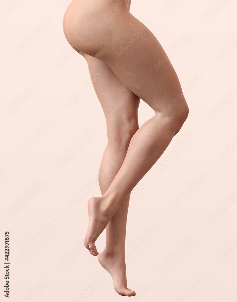 Female legs. Beige background. Spa beauty concept. Female legs. Beige background. Spa beauty concept.