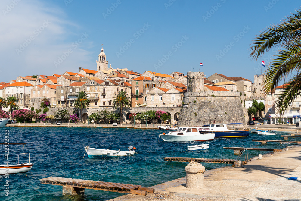 Korcula old town seen from the seafront promenade in Korcula island in Croatia on a sunny summer day.