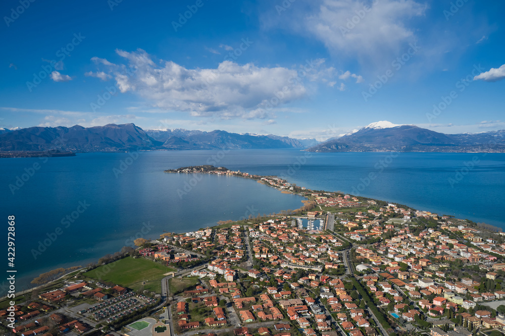 High altitude panorama of Sirmione city, Colombare, Italy. Sirmione winter aerial view. Aerial panorama of Lake Garda. Italian resorts Lake Garda aerial view.
