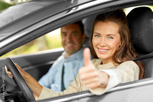 Vászonkép car driving instructor and woman showing thumbs up