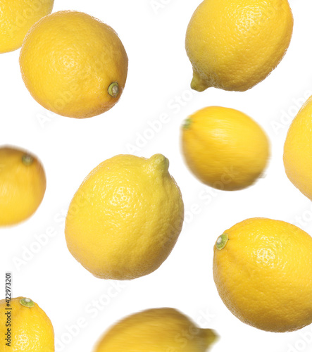 Fresh ripe lemons falling on white background