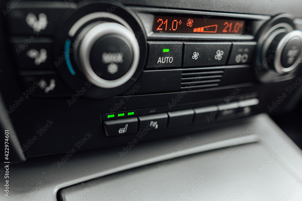 the climate control panel in a car with bench heating on has a visible level of interior heat