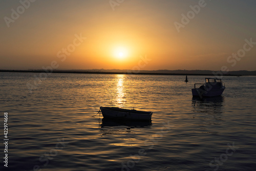 In the golden sunset a boat stranded at sea © Reynolds Photography