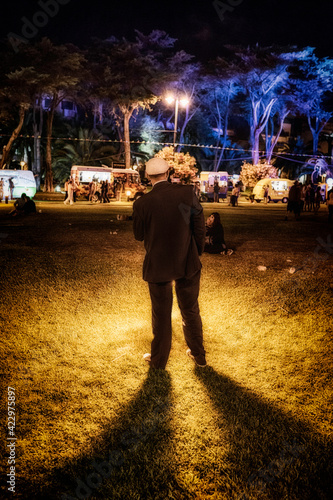 Disturbing image of a man in a park with a light source appearing to be born from him