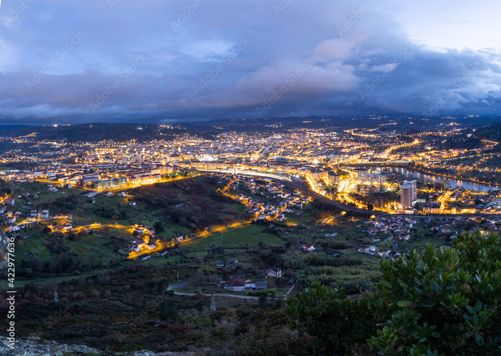 Ourense town lights up at sunset. Ourense is the capital of Galicia, Autonomous community in the Northwest of Spain. 