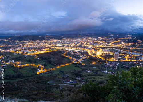 Ourense town lights up at sunset. Ourense is the capital of Galicia, Autonomous community in the Northwest of Spain. 