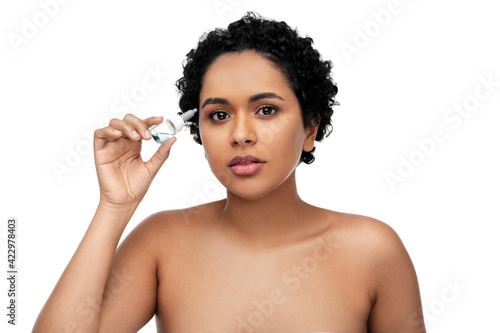 young african american woman with eye drops