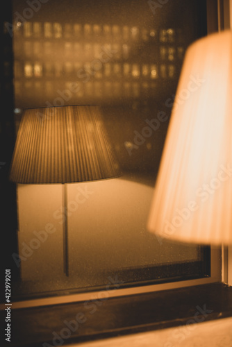 floor lamp with warm light and reflection in the window