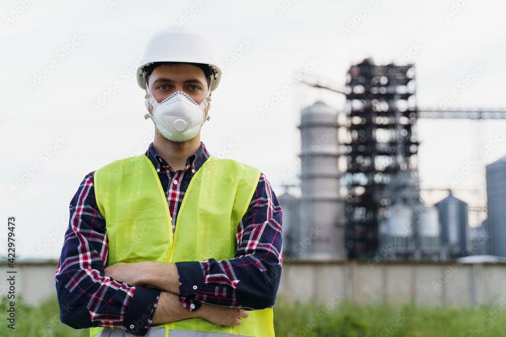 Male engineer in hard hat on factory background Male engineer in hard hat on factory background