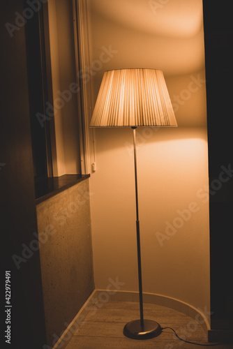 floor lamp with warm light and reflection in the window