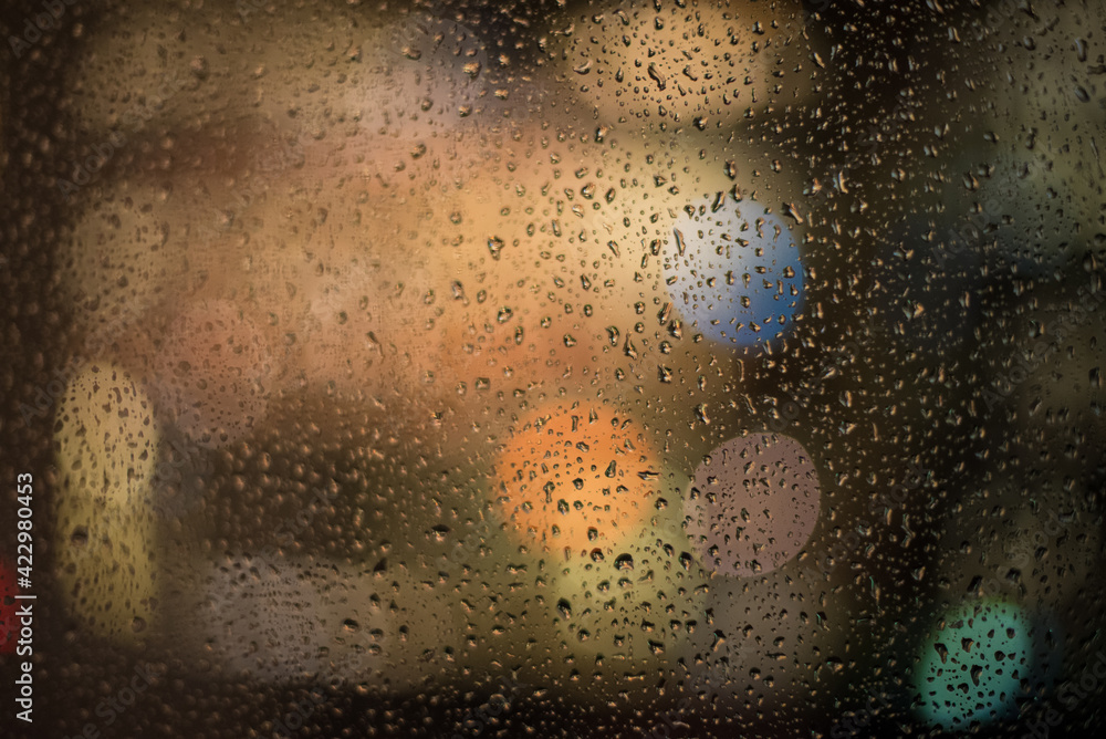 raindrops and night lights through the window raindrops and night lights through the window