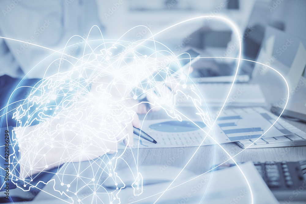 Double exposure of man's hands holding and using a phone and international business theme drawing. Double exposure of man's hands holding and using a phone and international business theme drawing.