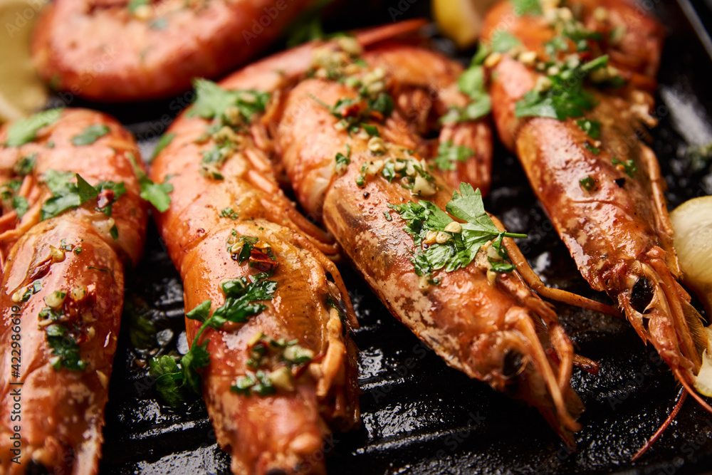 Grilled large shrimps with lemon and spices on the grill pan Grilled large shrimps with lemon and spices on the grill pan