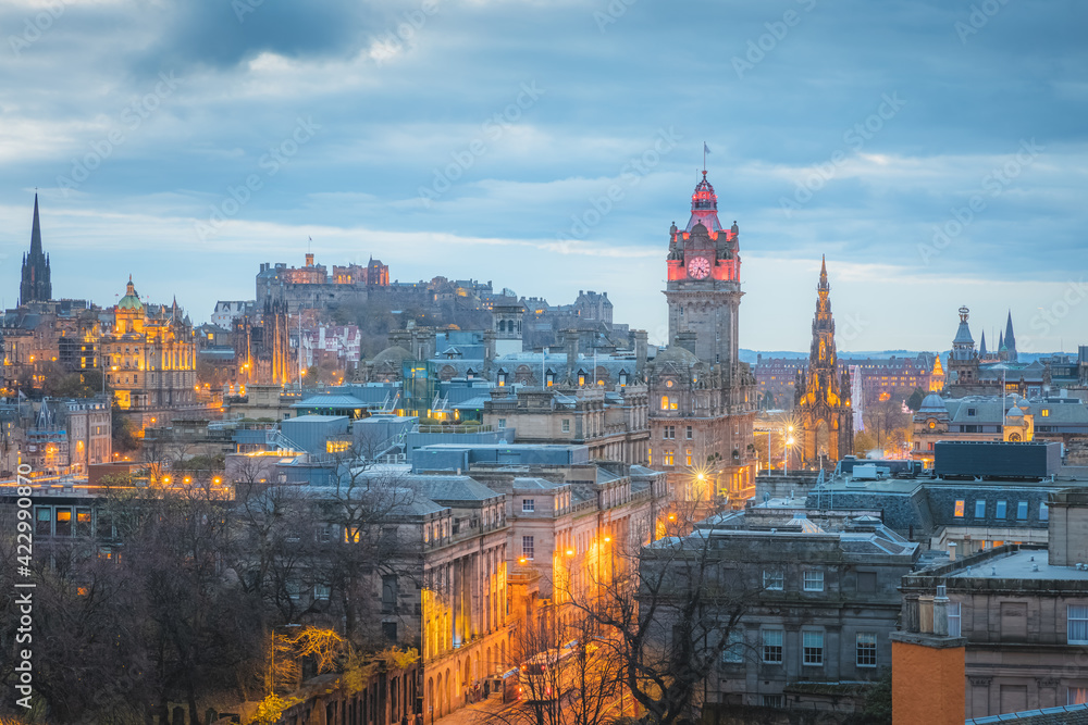 Cityscape night view from Calton Hill of illuminated Edinburgh old town skyline, Princes Street, Balmoral Clock Tower and Edinburgh Castle in the capital city of Scotland.