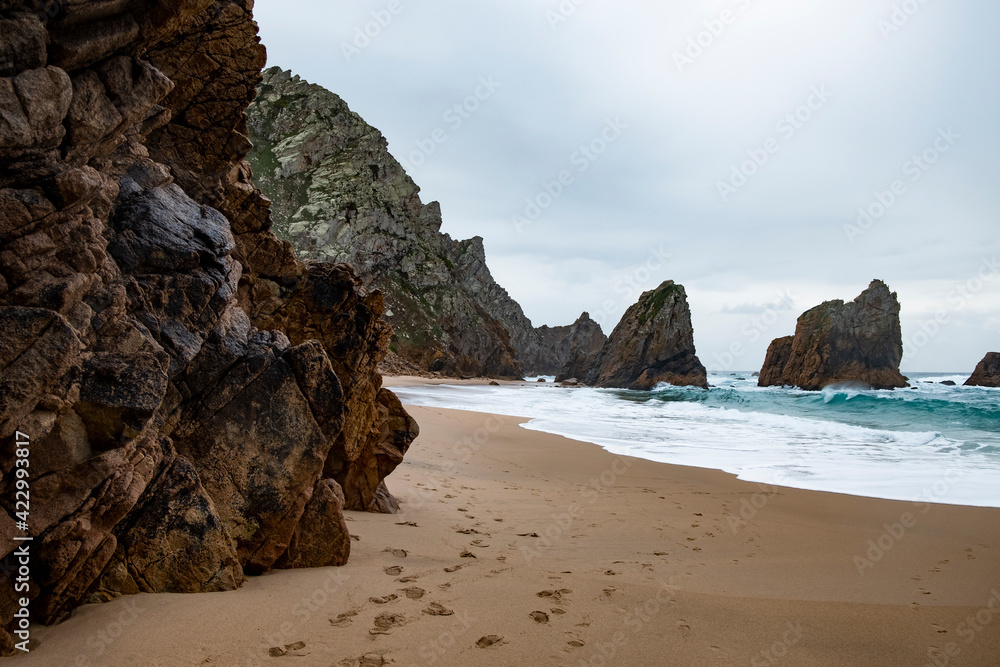 Close view of two beautiful cliffs in the sea at the most western cape of Europe — Cabo da Roca, Portugal. Natural photo of two stone cliffs int the Atlantic ocean near Cape Rock in Portugal. Close view of two beautiful cliffs in the sea at the most western cape of Europe — Cabo da Roca, Portugal. Natural photo of two stone cliffs int the Atlantic ocean near Cape Rock in Portugal.