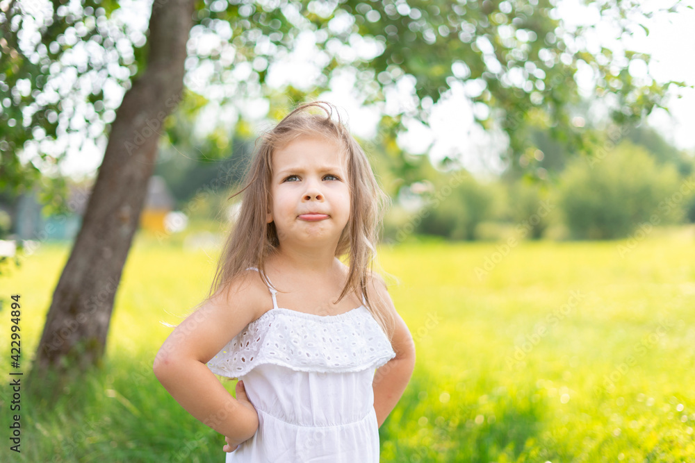 child girl with long hair playfully pouting on a summer day child girl with long hair playfully pouting on a summer day