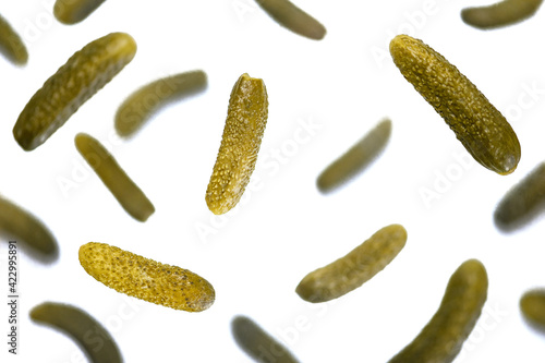 . Lots of fresh pickled cucumbers are flying in the air. Isolation on a white background. Levitation