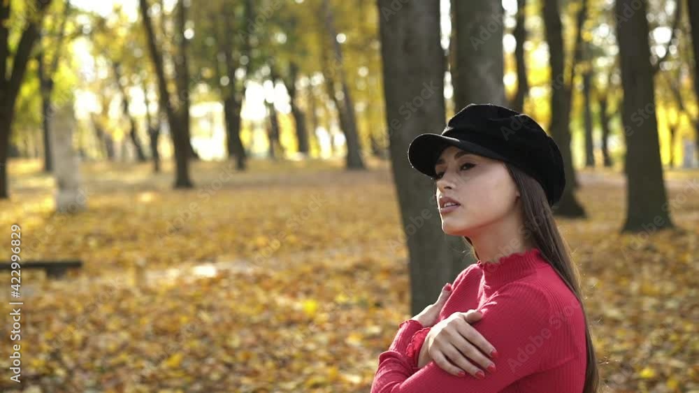 Brunette in beret, posing, caressing herself and flirting at camera in park Brunette in beret, posing, caressing herself and flirting at camera in park