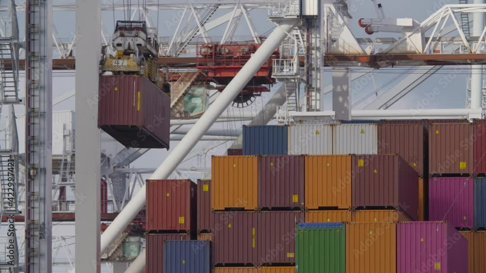 A large container ship being loaded and unloaded at the docks in the UK port of Southampton.