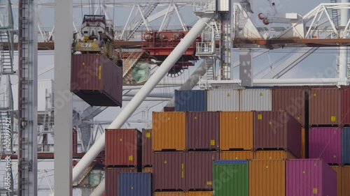A large container ship being loaded and unloaded at the docks in the UK port of Southampton.
